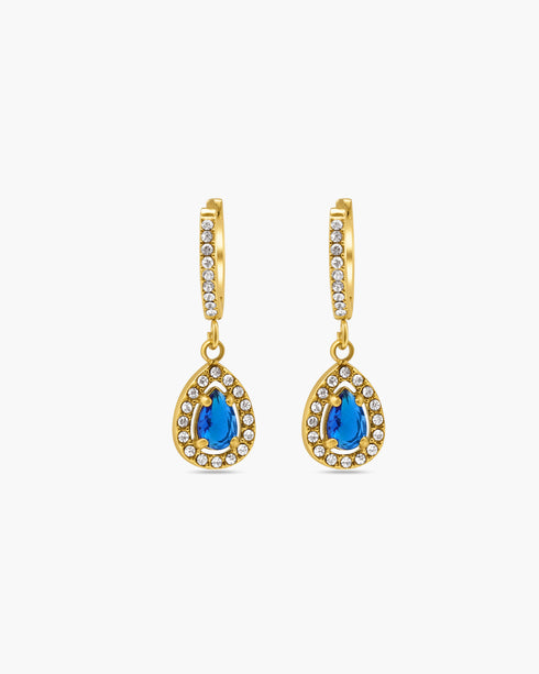Gold earrings with blue gemstones on a white background
